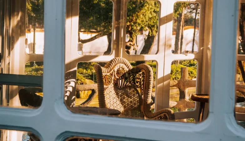 Sunlit home conservatory extension with wicker chairs