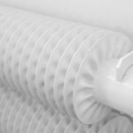 White radiator mounted on wall in a UK home