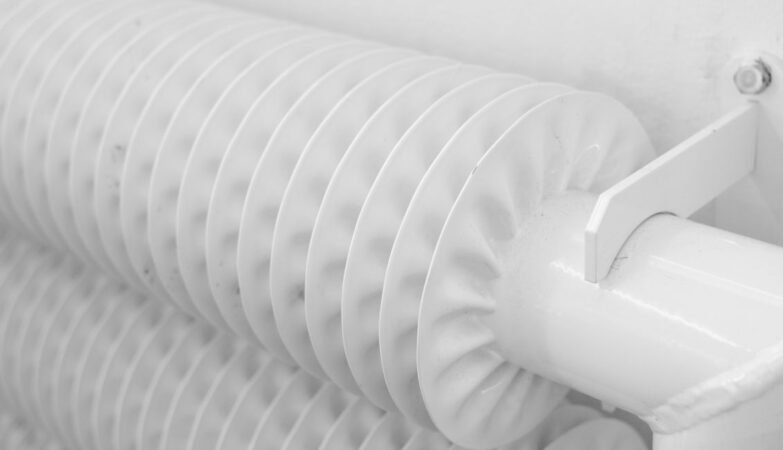 White radiator mounted on wall in a UK home