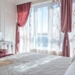 Cosy bedroom with thick curtains that help reduce outside noise