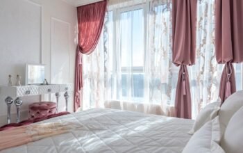 Cosy bedroom with thick curtains that help reduce outside noise