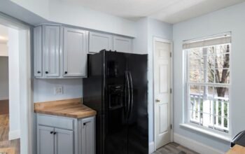 Modern UK kitchen with fridge freezer and large window