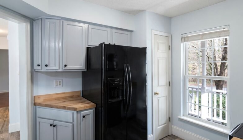 Modern UK kitchen with fridge freezer and large window