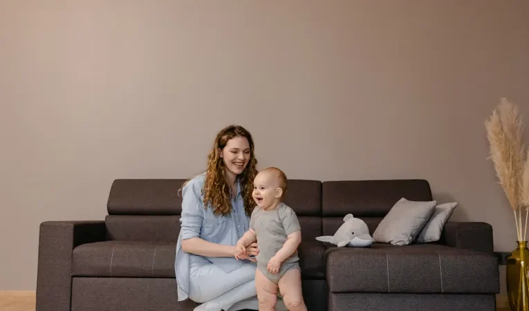 Parent and child in a childproofed living room
