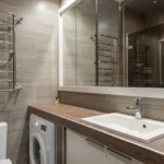 Modern bathroom with tiled wall and mirror