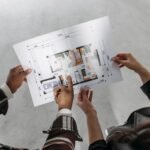 Couple reviewing house extension blueprint and planning permission documents