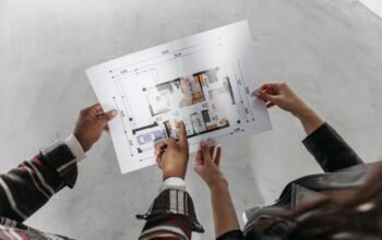 Couple reviewing house extension blueprint and planning permission documents