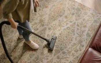 Woman vacuuming a patterned carpet at home
